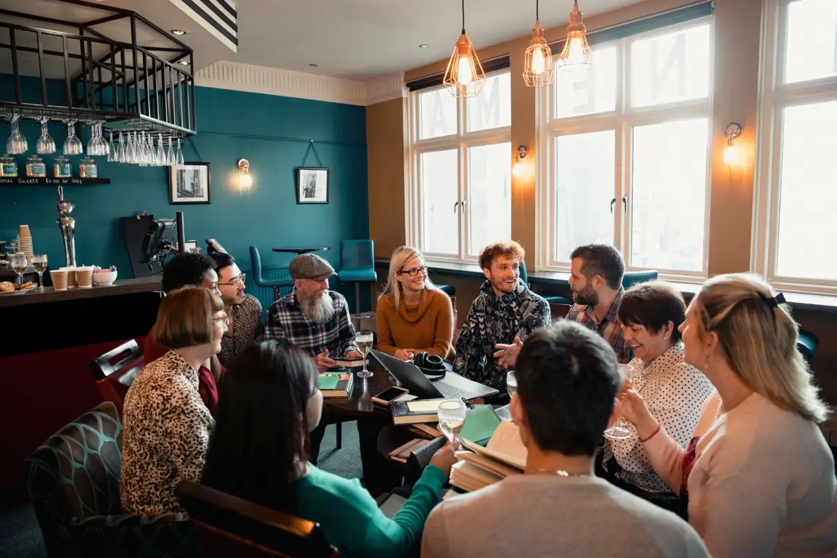 People gathering around a book and a shared interest