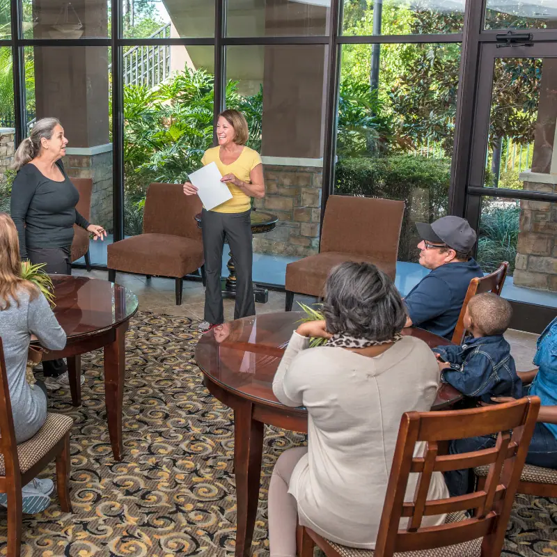 People gathered around tables at a community center