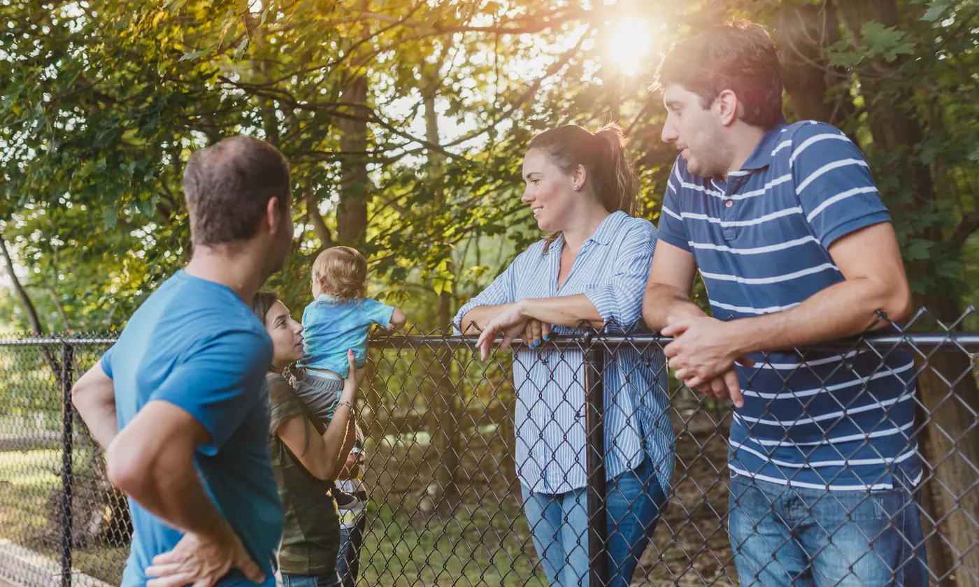 Neighbors of different ages talking outdoors