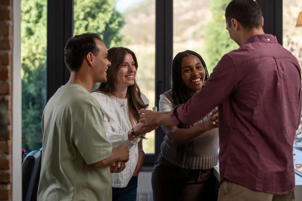 People talking together at an indoor gathering; illustrative photo