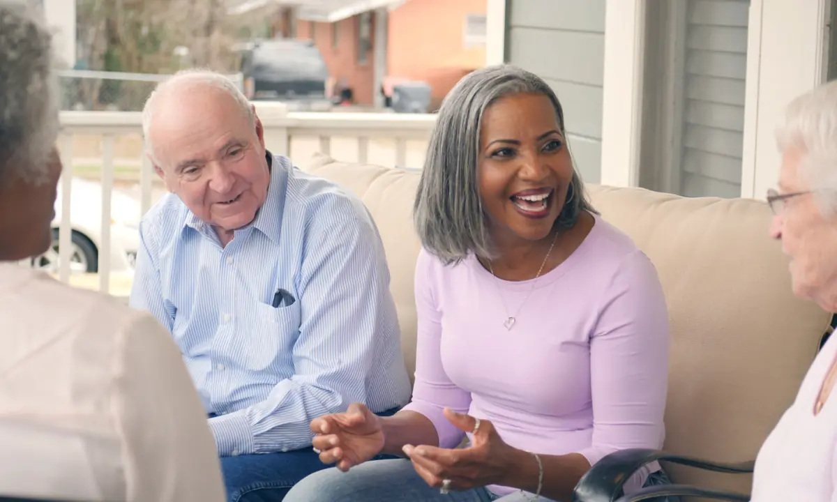 Neighbors talking together on a porch