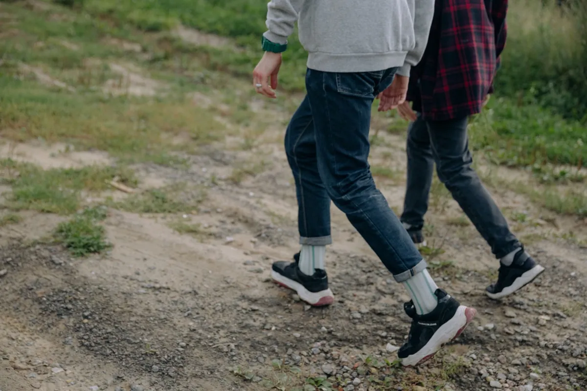 Two people walking together along a path